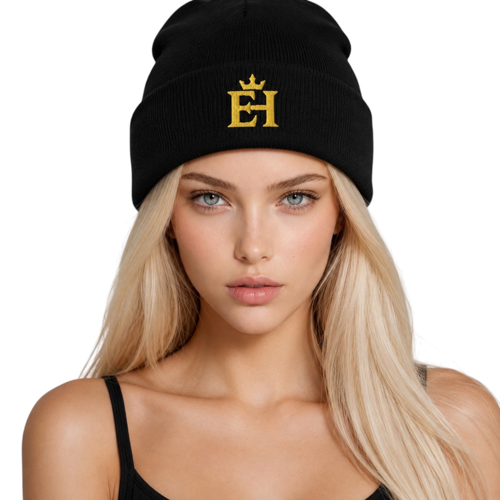 Woman wearing a black EH Crown Signature Cuffed Beanie with gold embroidered EH Crown logo, front view.