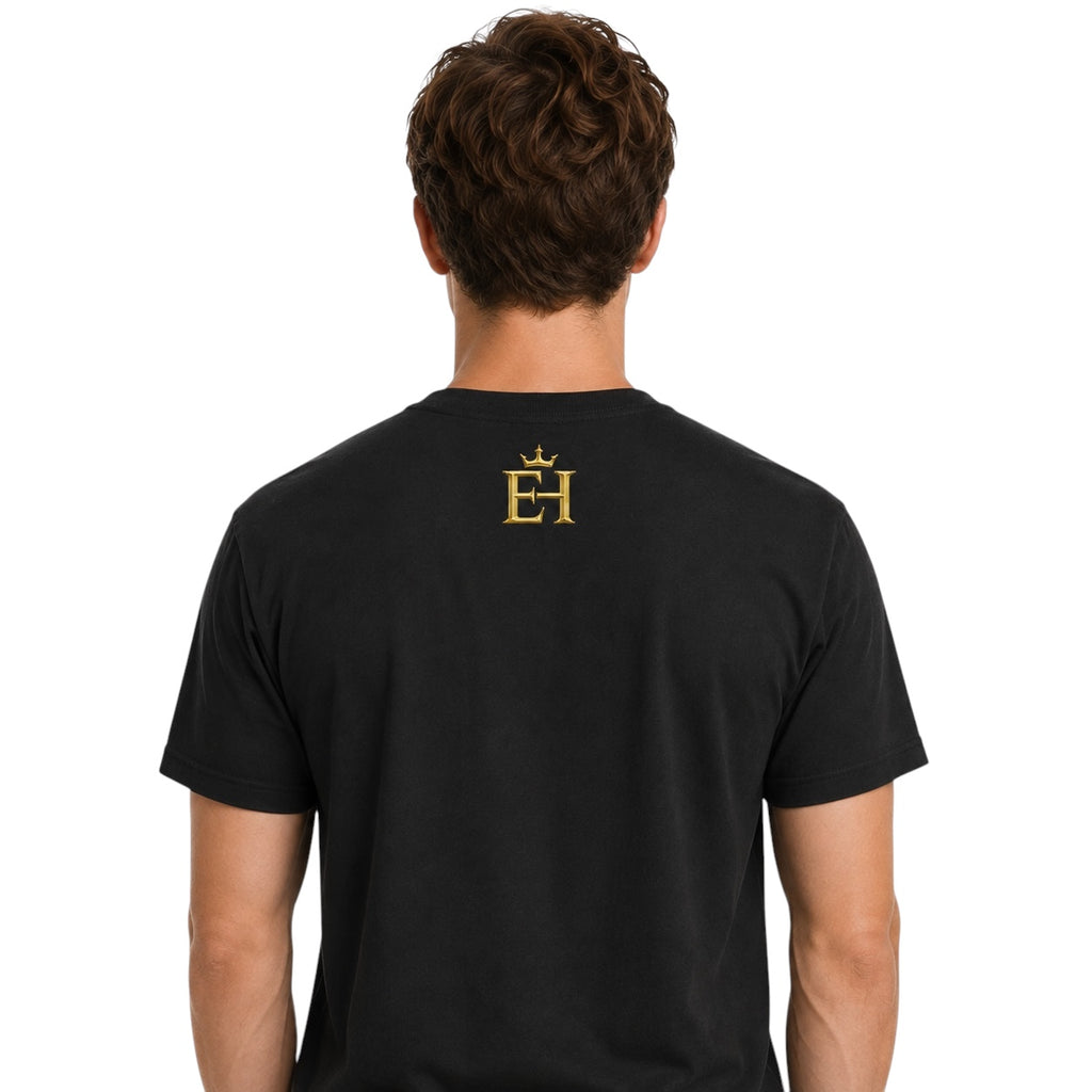 Back view of a man wearing the black EH Crown Signature Heavyweight T-Shirt with gold EH Crown logo on the upper back, on a light neutral background.