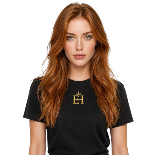 Woman wearing the black - EH Crown Signature Heavyweight T-Shirt with gold EH Crown logo on the front, studio portrait on a light neutral background.