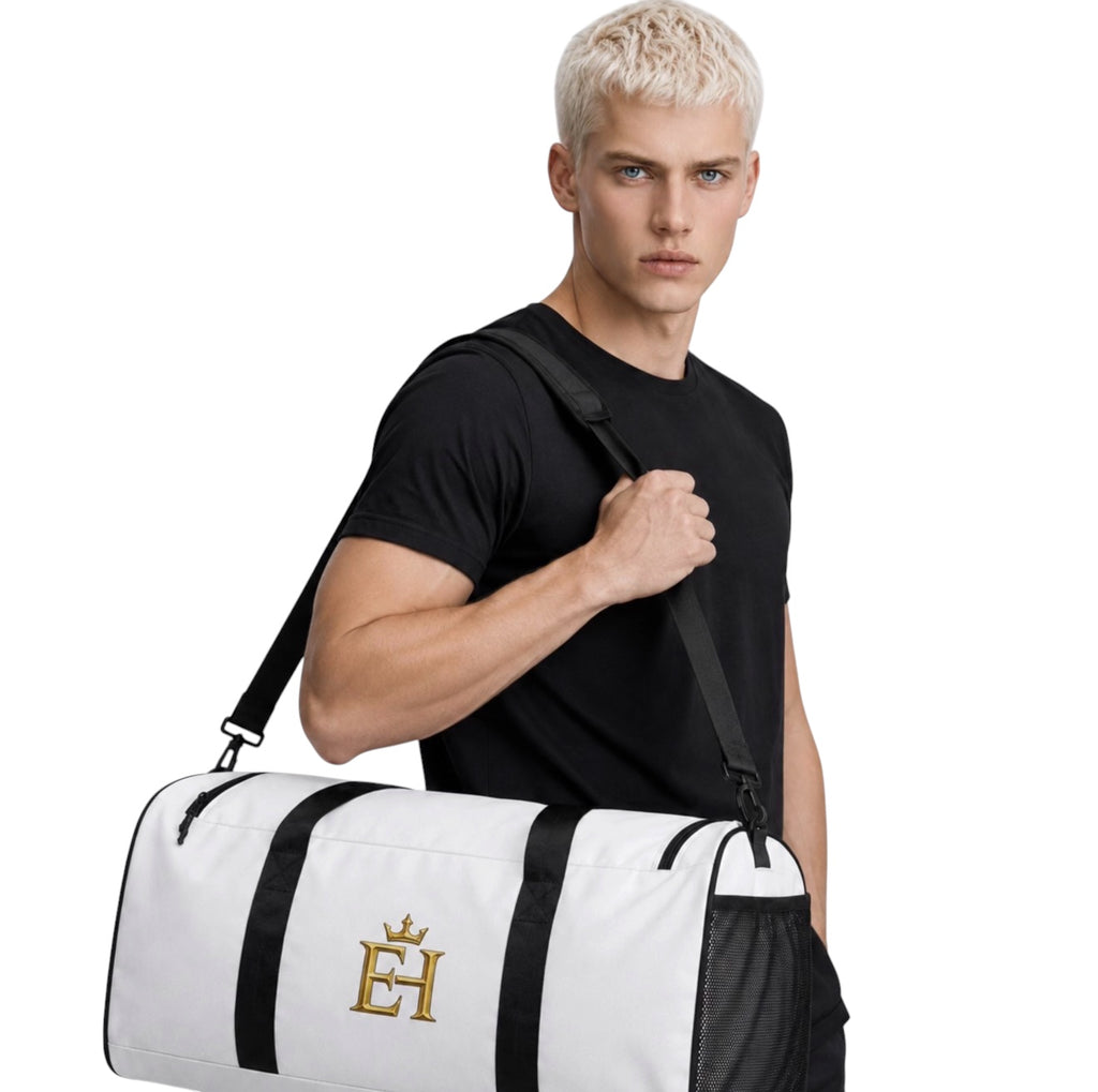Man carrying the white EH Crown Signature Premium Duffle Bag with black trim and gold EH Crown logo.
