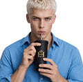 Man in a blue shirt drinking from the EH Crown Monarch 20oz Tumbler with gold EH Crown logo.