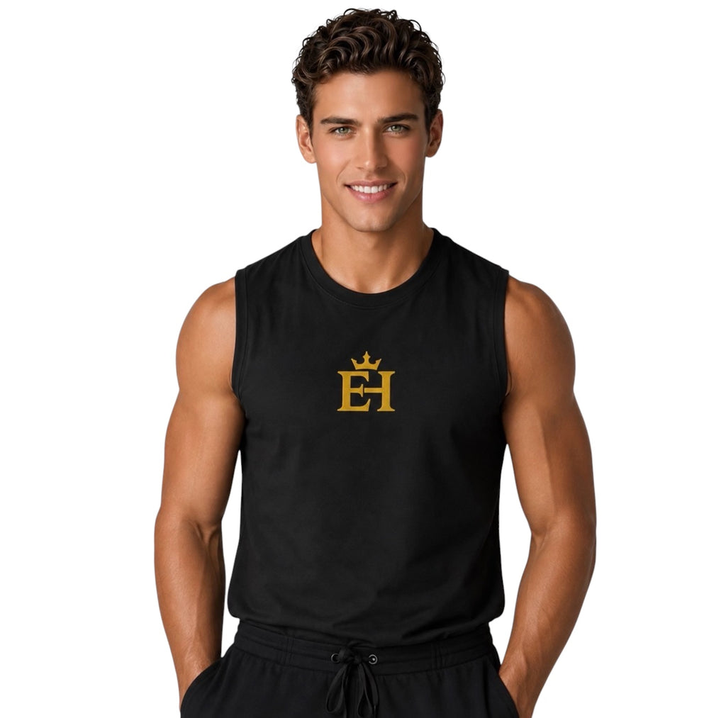 Man wearing a black premium muscle tank with gold EH Crown embroidery in a front-facing editorial pose.