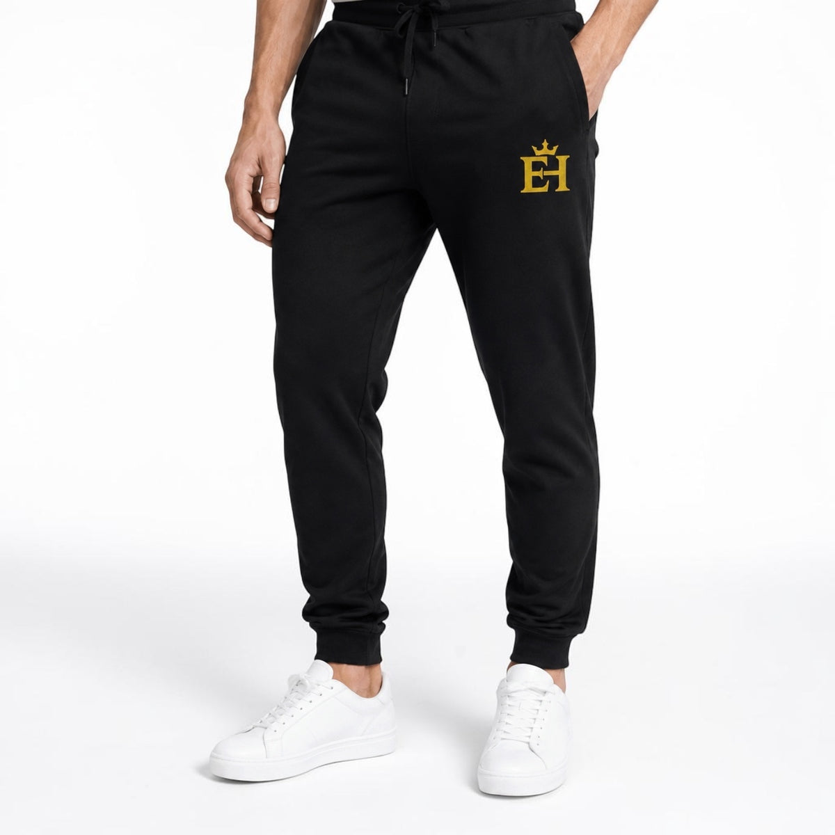 Close-up of black EH Crown Signature Premium Sweatpants on a male model, highlighting the gold embroidery and fit.