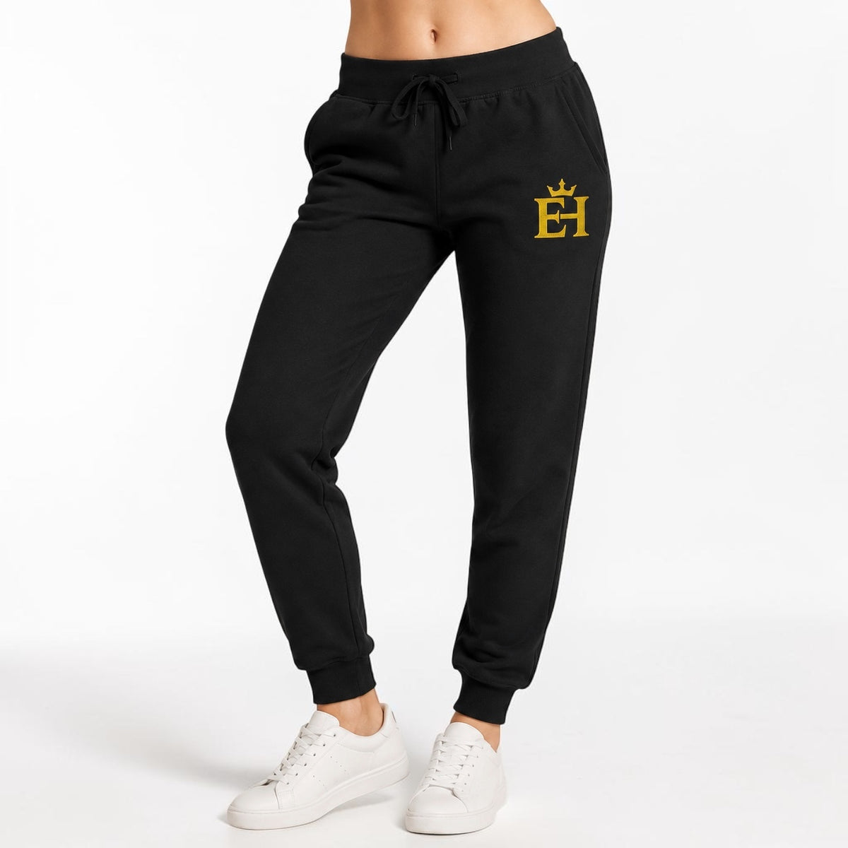 Close-up of black EH Crown Signature Premium Sweatpants showing the gold EH Crown embroidery and drawstring waist.