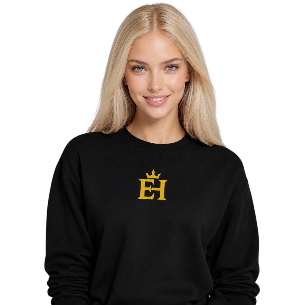 Woman wearing the black EH Crown Signature Premium Sweatshirt with gold embroidered EH Crown logo, front view.