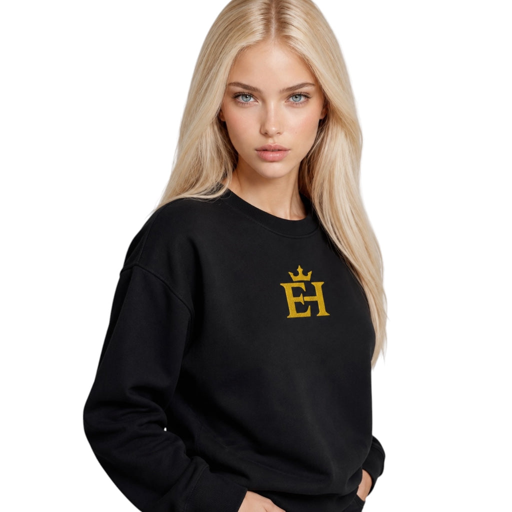 Woman wearing the black EH Crown Signature Premium Sweatshirt with gold embroidered EH Crown logo, three-quarter view.
