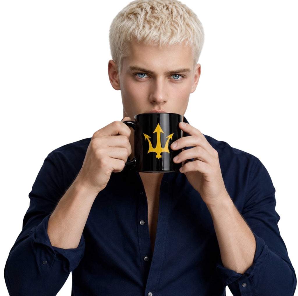 Man holding INSPIRED Black Glossy Mug with gold trident logo