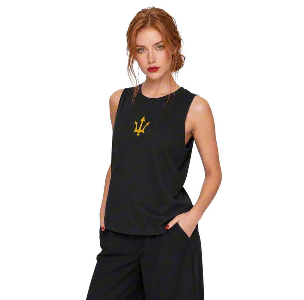 Female model wearing the black INSPIRED Muscle Tank with gold infinity-trident emblem, angled view.