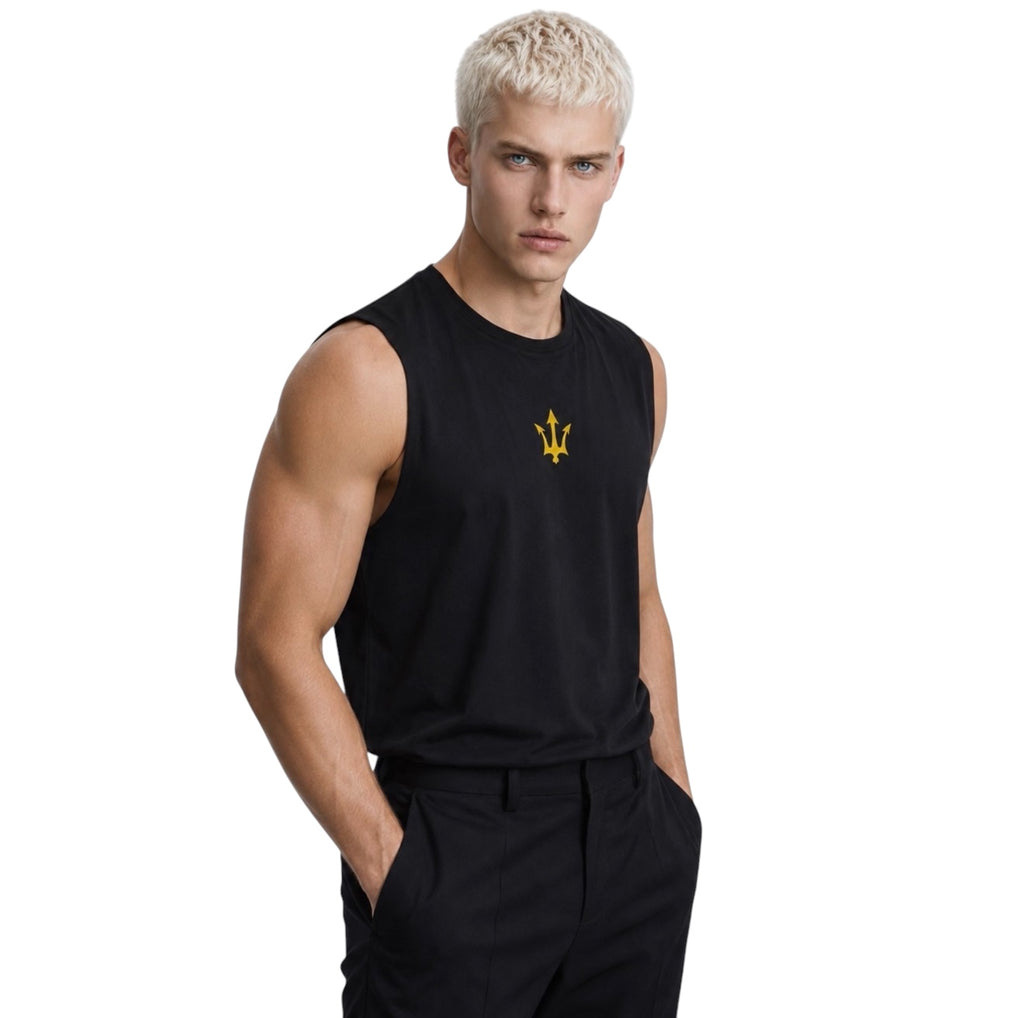 Male model wearing the black INSPIRED Muscle Tank with gold infinity-trident emblem, angled view.