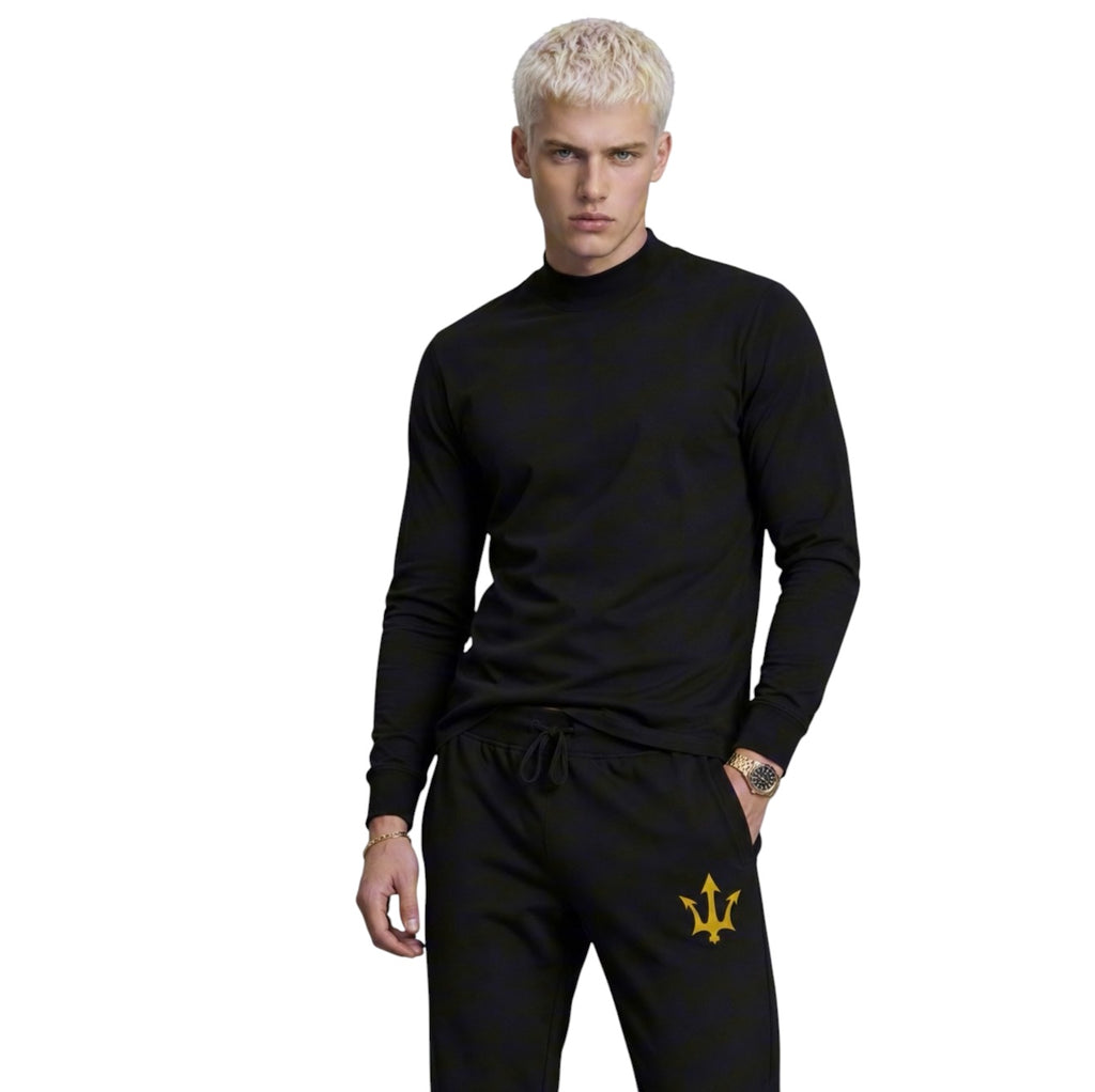 Male model wearing INSPIRED Sweatpants in black with gold infinity-trident emblem, styled front view.