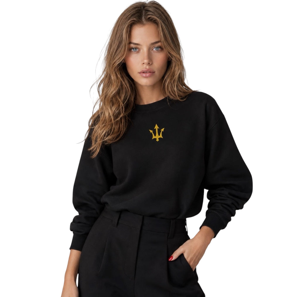 Female model wearing the INSPIRED Sweatshirt in black with gold infinity-trident emblem.